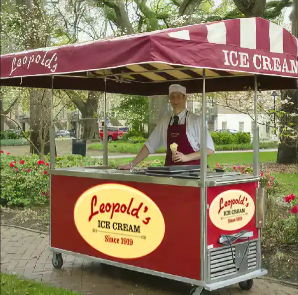 Friendly leopolds worker serving ice cream from catering cart