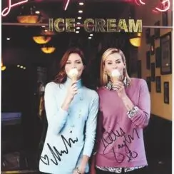 Mini Anden and Niki Taylor pictured in front of the store window licking ice cream